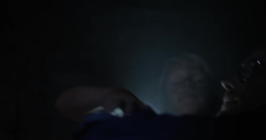 Two men are struggling in a dark cave