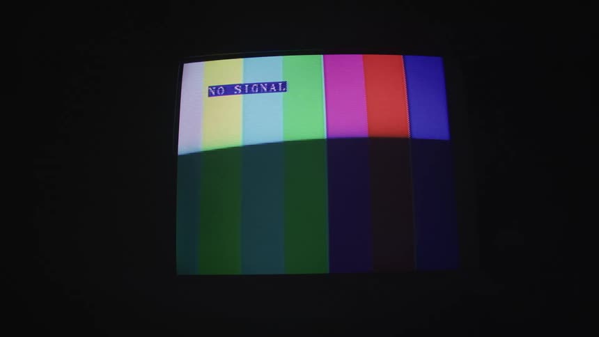 A flashing television with colorful stripes in a dark room