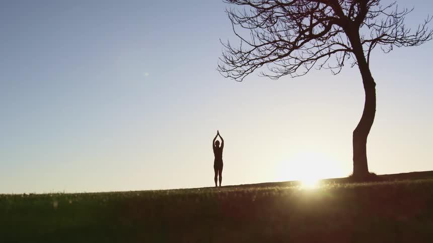 A woman doing yoga outside