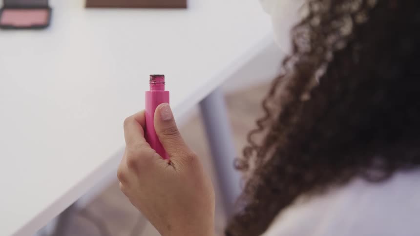 A woman putting make up on