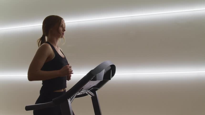 A woman is running on the treadmill
