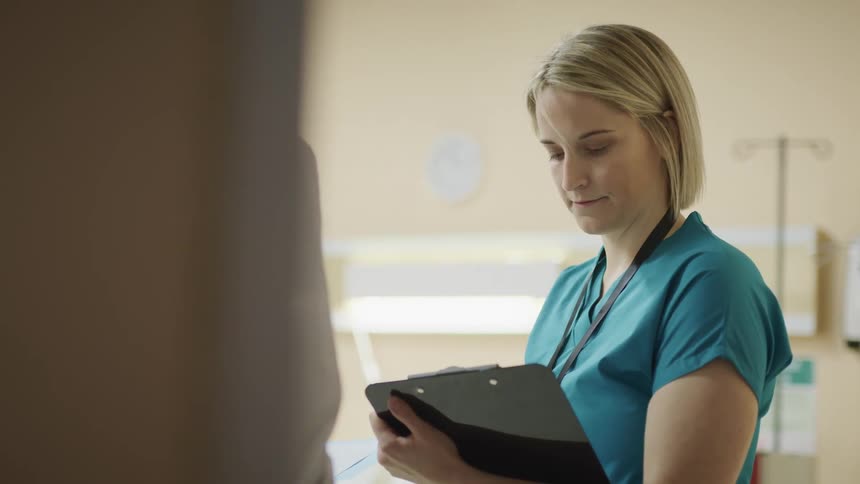 Female nurse takes notes from a doctor in the hospital