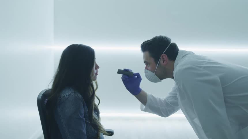 A doctor examines a girls eyes
