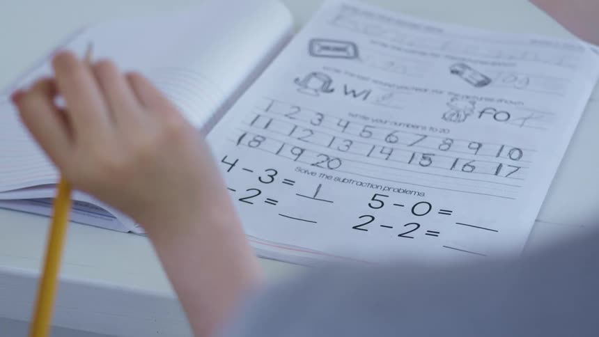 A child doing math work at a table