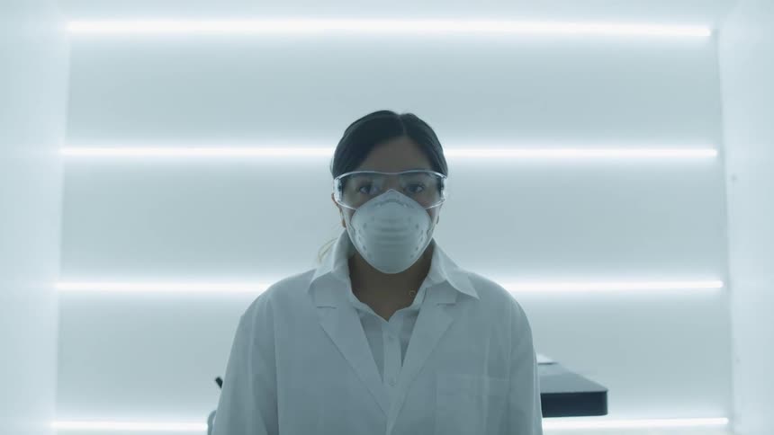 A scientist is wearing a face mask