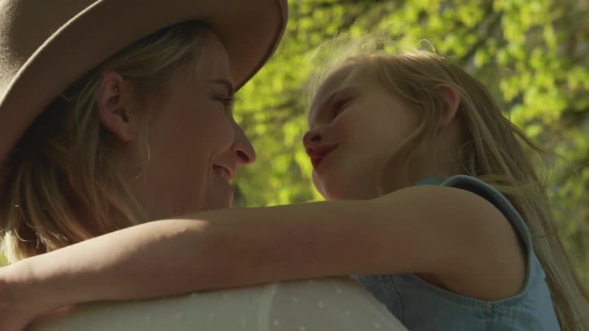 A mother holds her daughter and they talk and hug