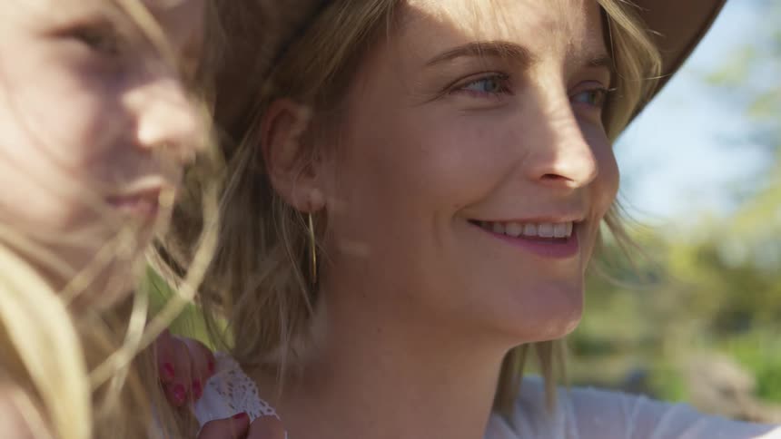 A mother looks at her daughter and smiles