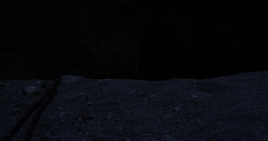 A rope being flung over the side of a cliff