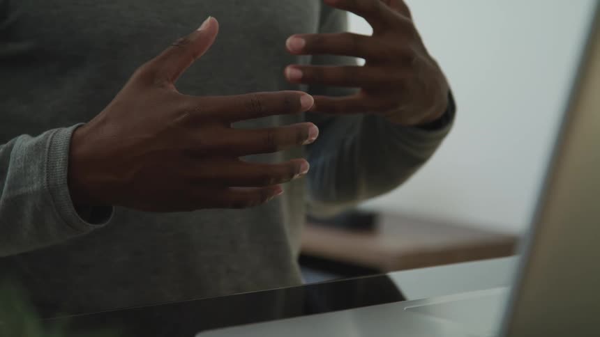 Close up of a young man hands while he explains something