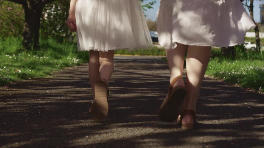 Two females walking down a path in a public park
