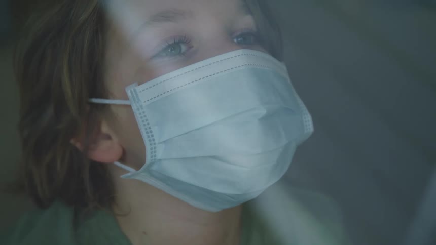 Close up of a boys face wearing a face mask