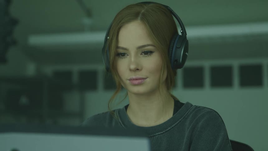 A person is working in the studio on a laptop