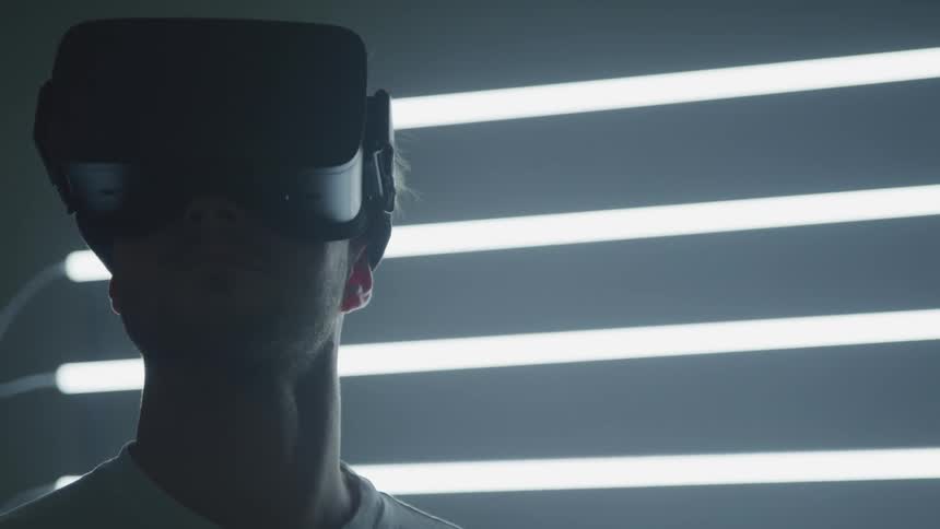 A man with a virtual reality headset on looking around