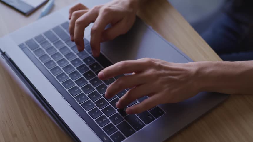 A person typing on a laptop