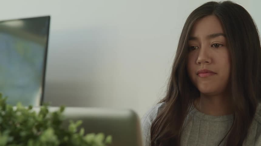 Young woman sitting in front of a computer screen