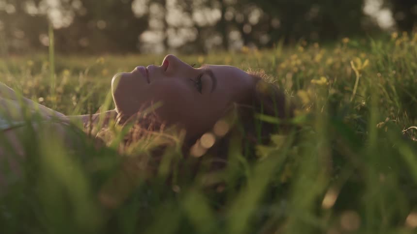 A teenage girl lying in the grass