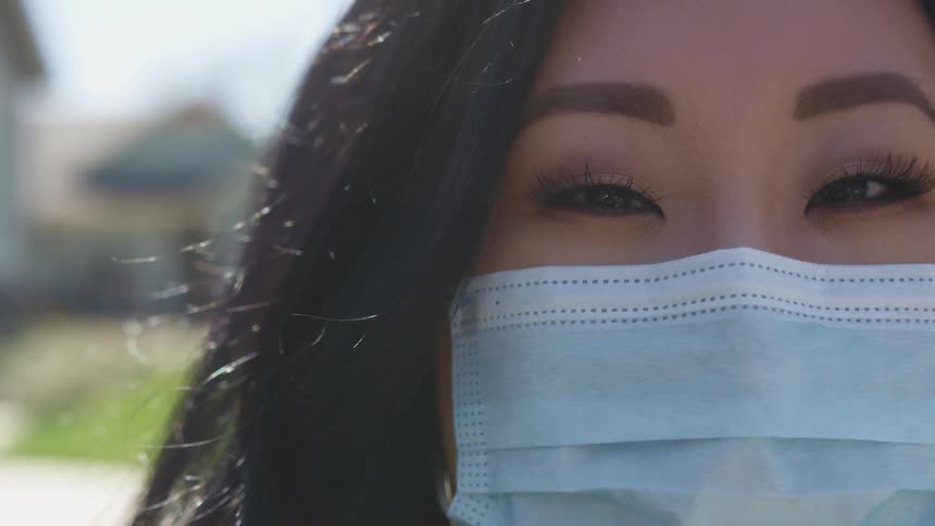 A woman is wearing a face mask
