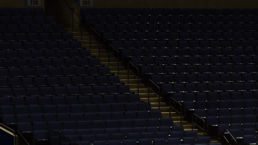 Rows of empty seats in a dark stadium