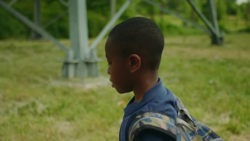 A child is bouncing a basketball as he travels