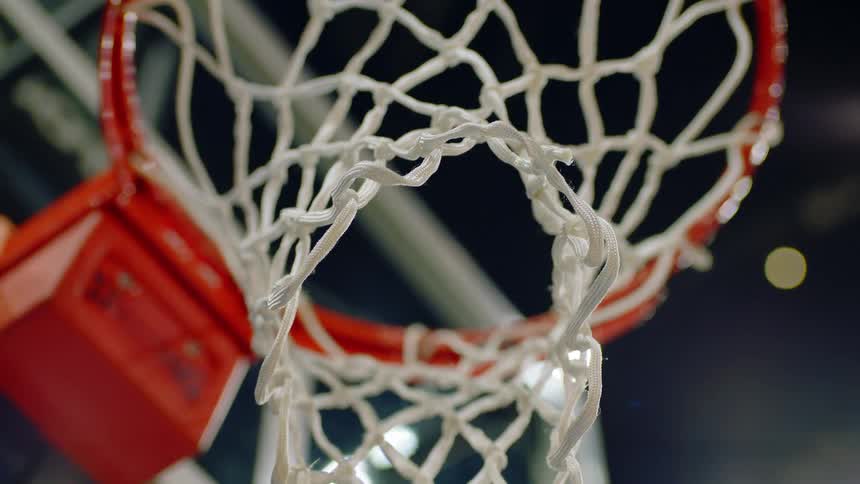 Close up of a metal orange hoop with its net