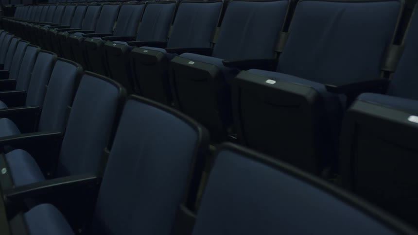 The seats in the theater have blue fabric