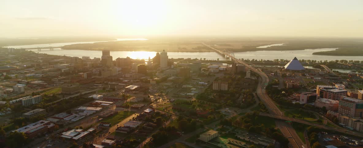 Aerial view of a skyline with cars and roads and a water way