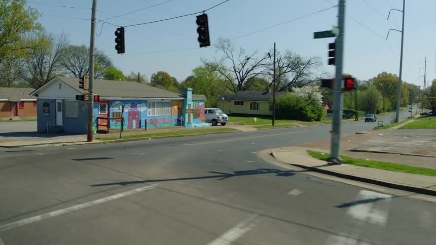 A car is driving on the road in the empty town