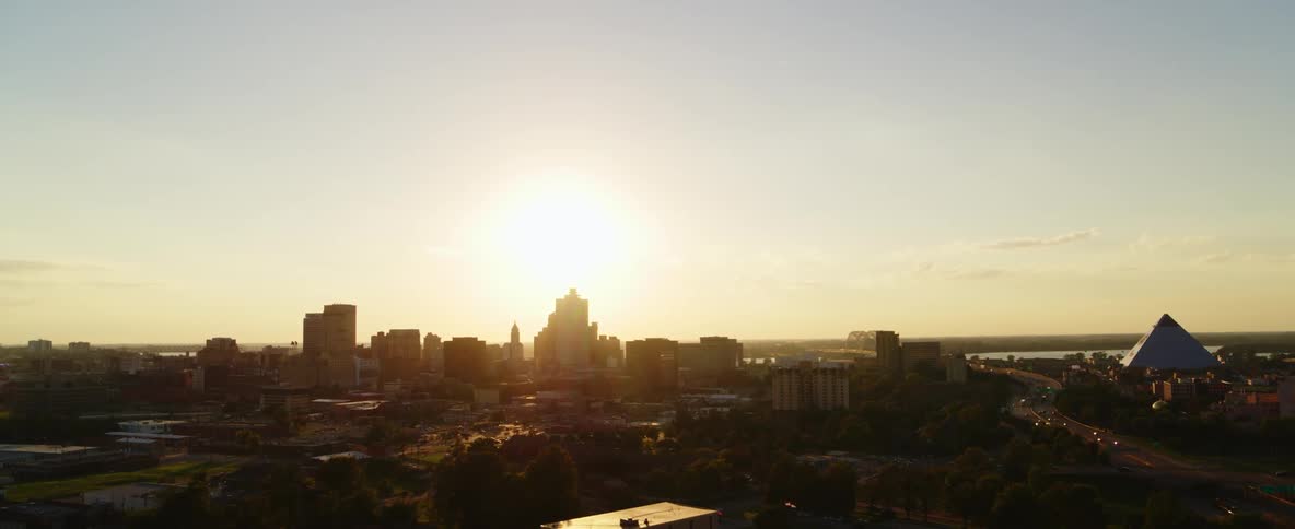 The low sun shines on the skyline of a metropolis under a clear sky