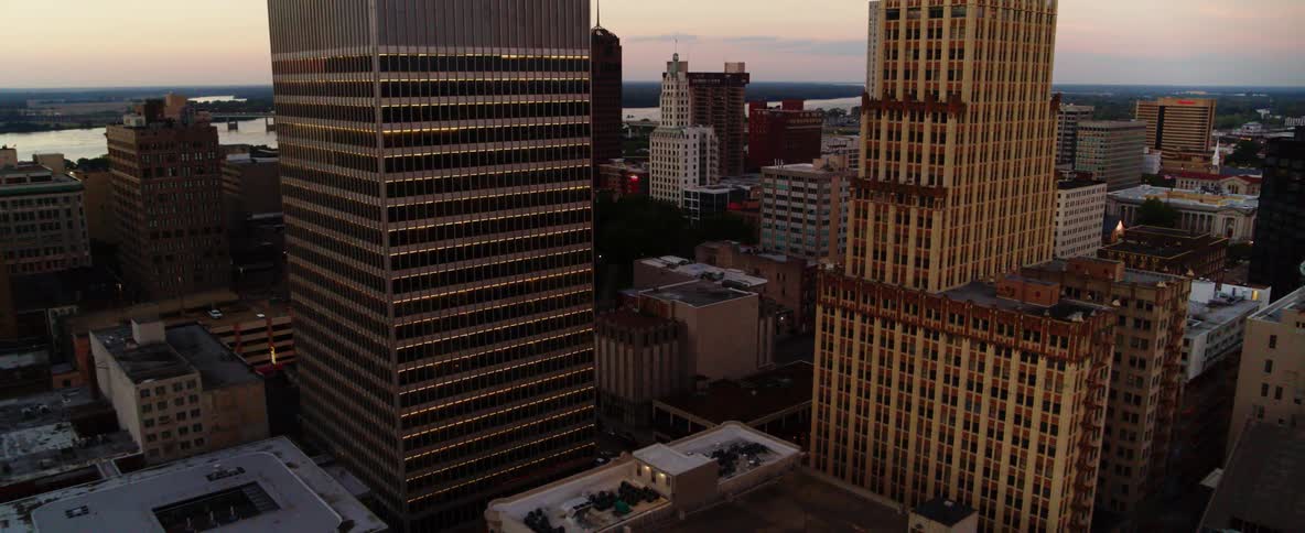 Aerial view of tall skyscrapers in city downtown at sunset