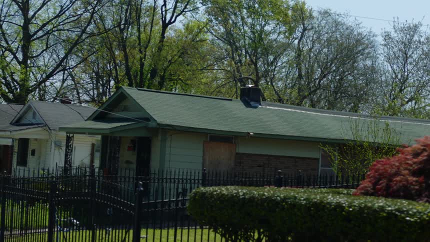 Twisting footage of small houses in a neighborhood in the day