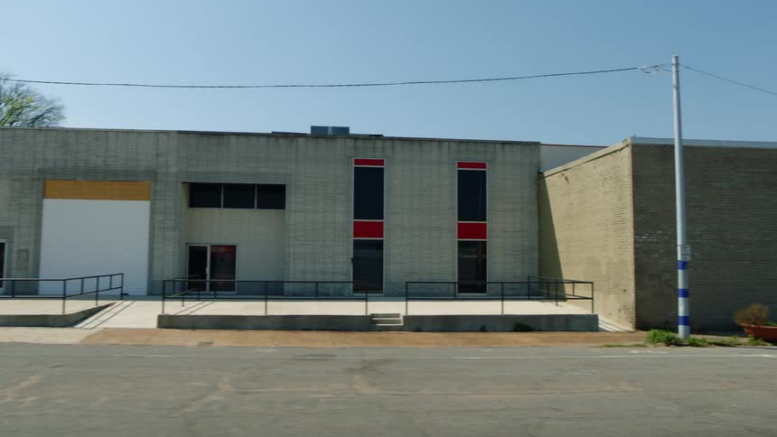 Businesses in a small town are shuttered with some having windows or doors boarded