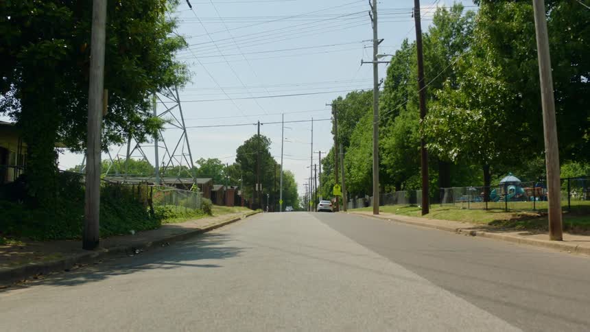 A street running through a neighborhood on a sunny day