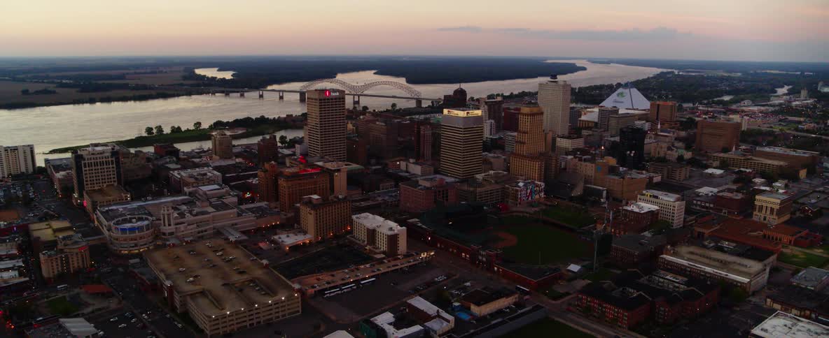 An aerial view of a city skyline with a waterway behind it