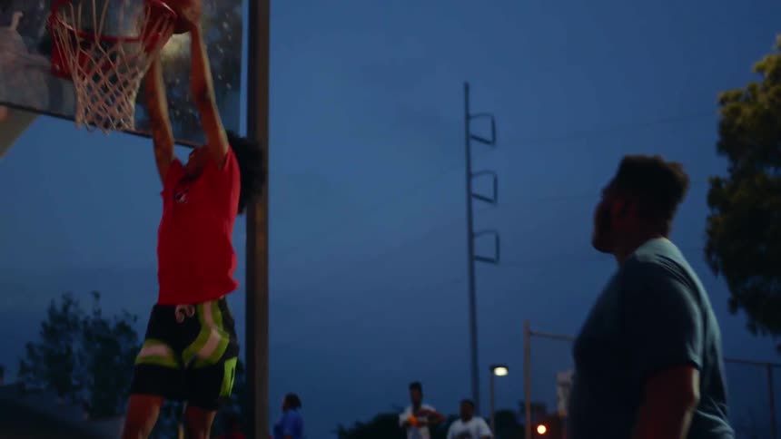 A player dunks the basketball on the court