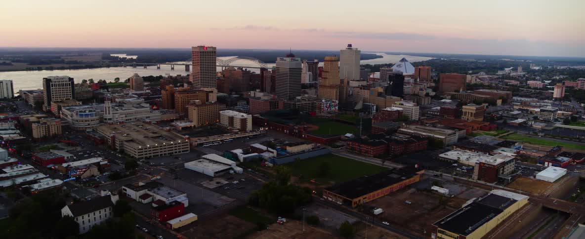 Aerial view of a city with a lake buildings and cars driving