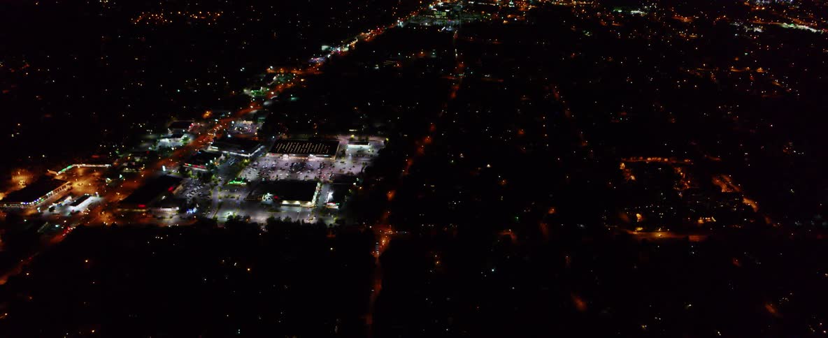 Aerial view of a small city commercial district at night