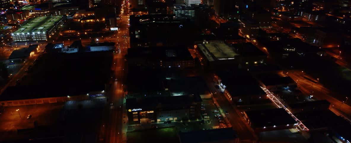 An aerial view of a city skyline with buildings and cars driving