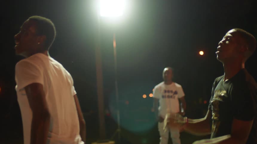 A man shoots the basketball at night