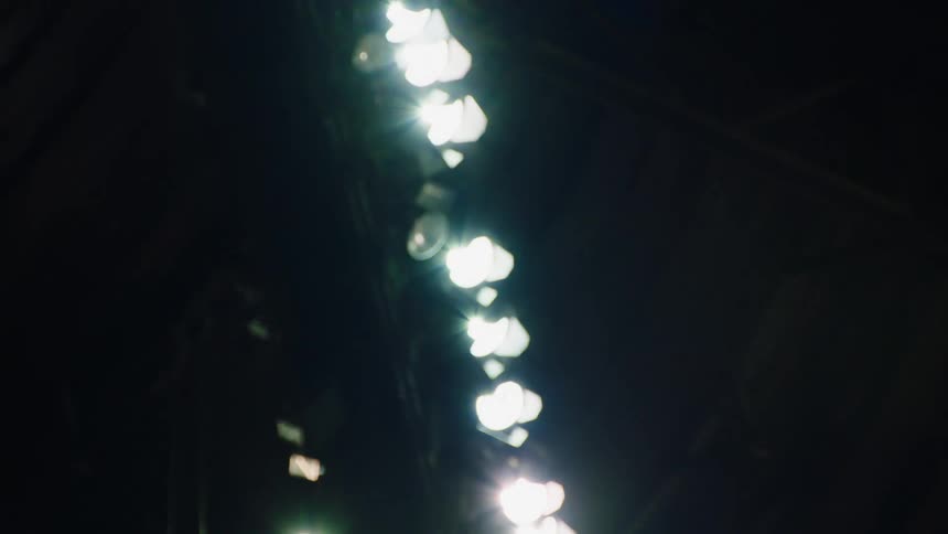 Spotlights lit up at an outdoor stadium