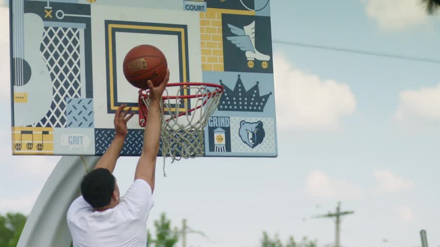 A group of black teens playing basketball in town