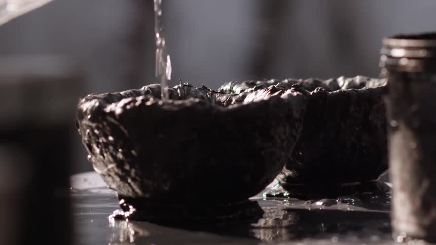 Water being poured in to a clay bowl