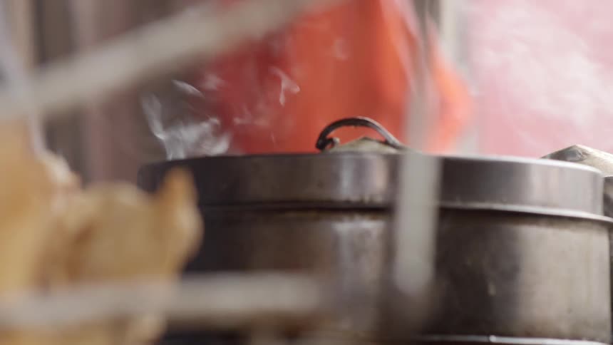 Steam rises from a silver pot