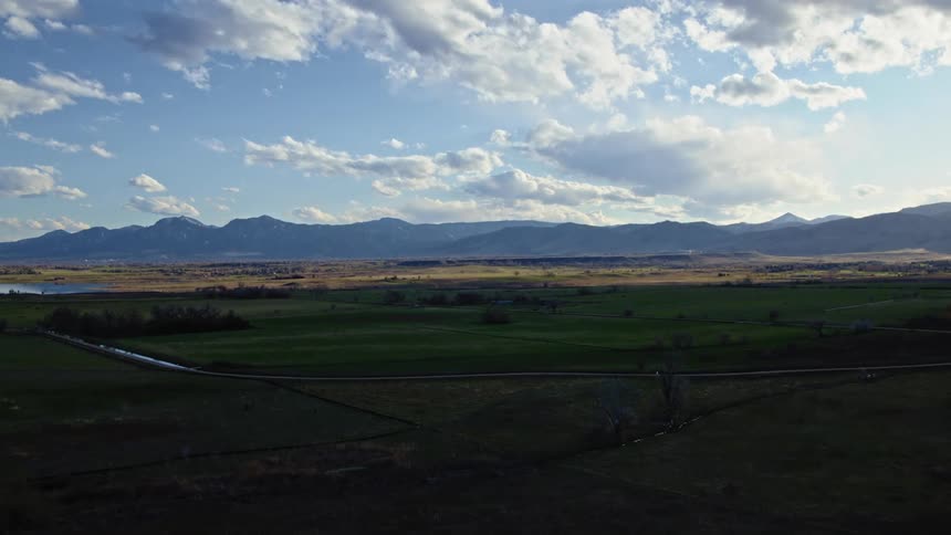 Stream runs through the field as mountains sit in the distance