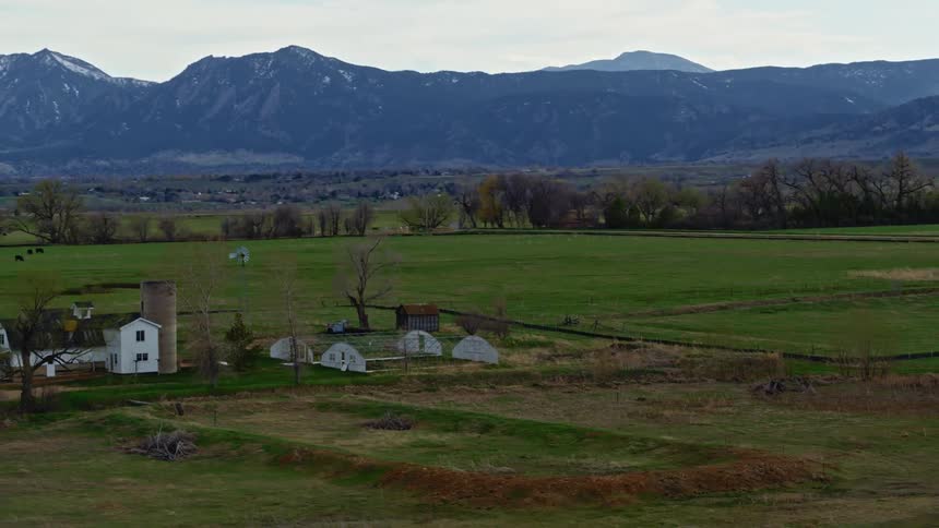 Aerial view of farmland with mountains in the distance
