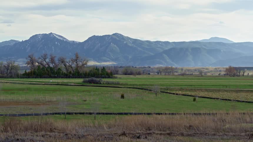 A field and distant mountains during the day