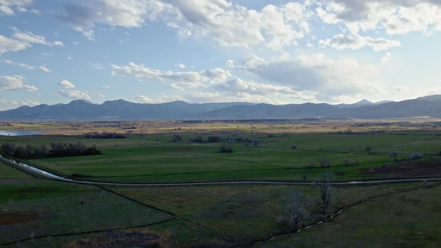 An aerial view of a grassland with a river running through it