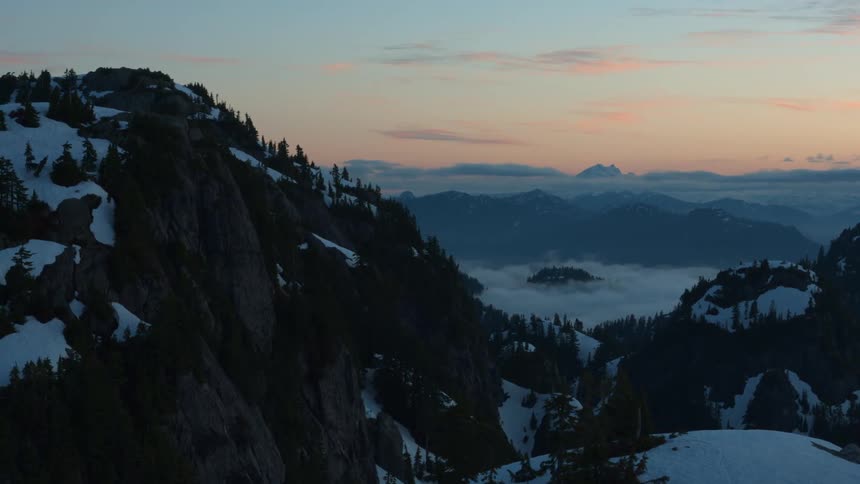 Mountains and vegetation with the sun rising in the background