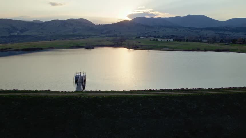The water in the lake is calm at sunrise