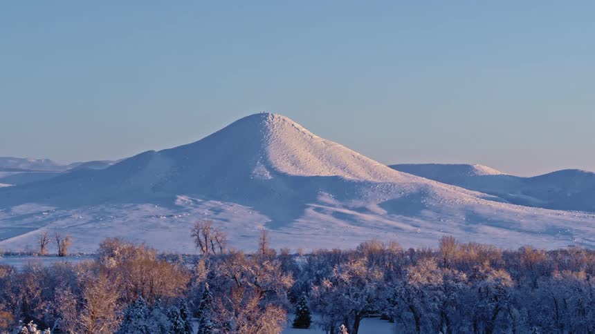 A snowy mountain peak in nature on a winter morning