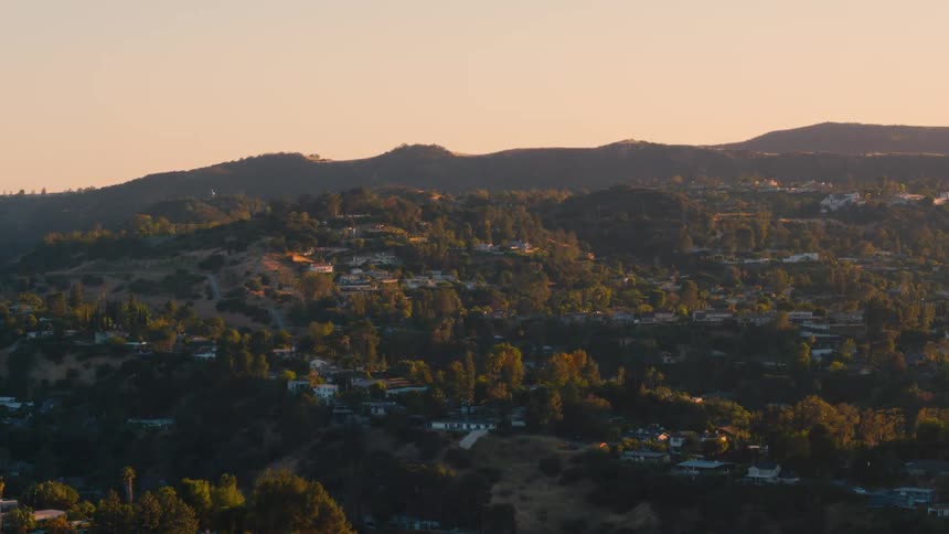 An aerial view of a landscape is displayed at dusk